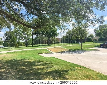 Green Park With Pathway From Shady Parking Lots In Coppell, Texas, Usa