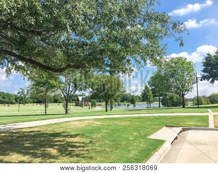Green Park With Pathway From Shady Parking Lots In Coppell, Texas, Usa