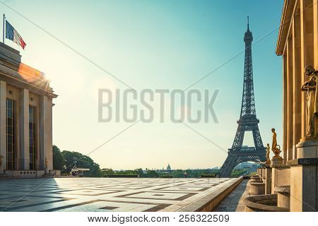 Paris Street With View On The Famous Paris Eiffel Tower On A Sunny Day With Some Sunshine