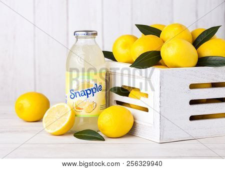 London, Uk - September 03, 2018: Bottle Of Snapple Lemon Juice On Wooden Background With Fresh Lemon