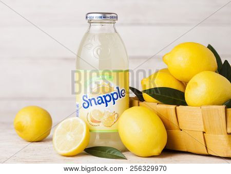 London, Uk - September 03, 2018: Bottle Of Snapple Lemon Juice On Wooden Background With Fresh Lemon