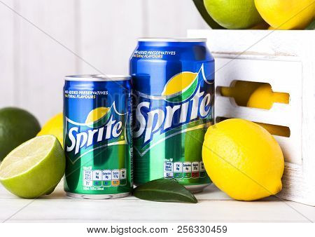 London, Uk - September 03, 2018: Aluminium Cans Of Sprite Drink On Wooden Background With Lemons And