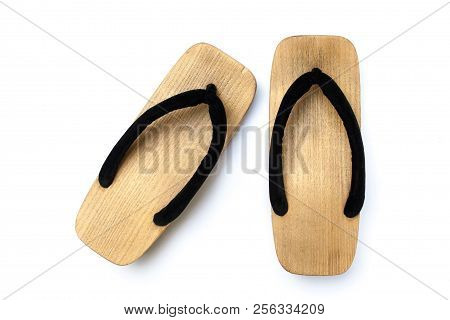 Close Up Old Used Wooden Japanese Sandal Isolated On White Background. It Is A Form Of Traditional J