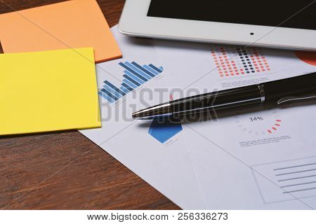 Tablet, Pen And Business Papers.