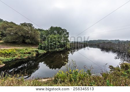A Foggy Morning Clears Enough To Show A Large Part Of The Manistee River In Michigan