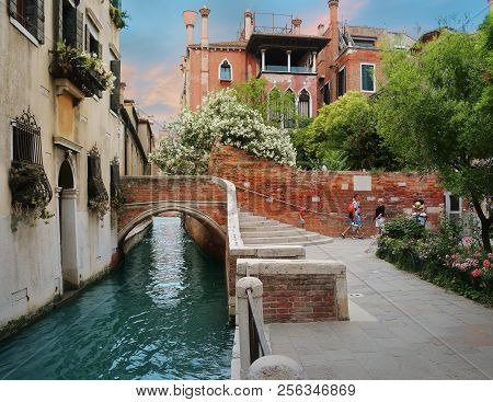 Venice, Italy, Jun 7, 2018: View Of An Inner Canal And  Bridge With Locals Walking By In Venice, Ita