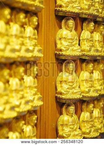 Nonthaburi, Thailand - August 26, 2018: Rows Of Small Golden Buddha Statues With Buddist Name On The