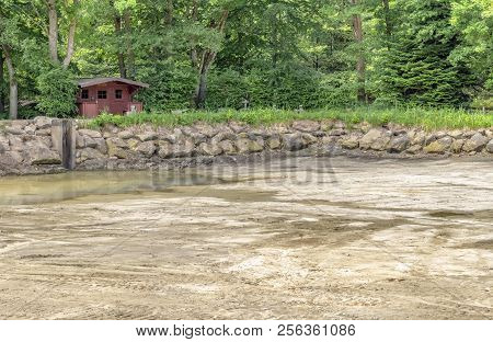 Dewatered And Excavated Lake Detail Near A Forest At Spring Time