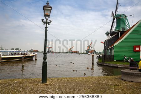 Zaanse Schans, Netherlands, August 19, 2015 - Traditional, Authentic Dutch Windmills At The River Za