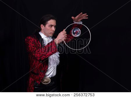 The Juggler Have A Balanse Ball On The Spoon