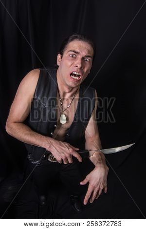 The Man Cuting His Own Arm By A Big Knife