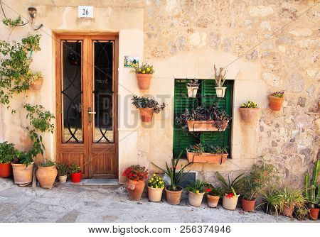 Valdemossa, Spain- 06/16/2018: Typical House Wall In Valdemossa, Mallorca, Spain With Beautiful Flow