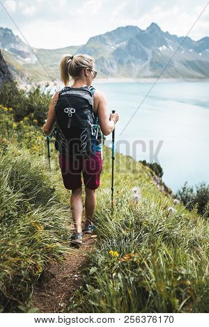 Adventurous Sportive Girl Hiking In Beautiful Alpine Mountains Next To A Lake