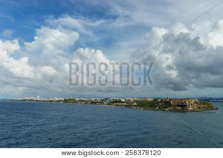 Scenic View Of Historic Colorful Puerto Rico City In Distance With Fort In Foreground From The Sea C