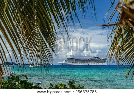Cruise Ship In Crystal Blue Water With A Palm On The Front