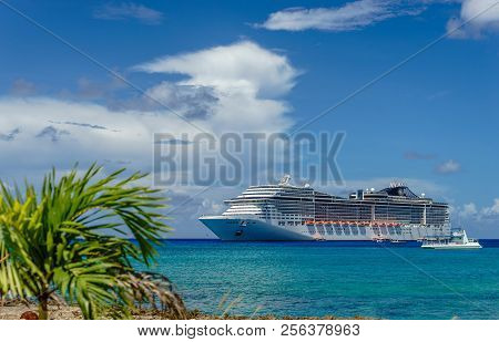 Cruise Ship In Crystal Blue Water With A Palm On The Front