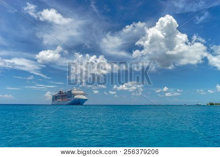 Cruise Ship In Crystal Blue Water And Beautiful Clouds