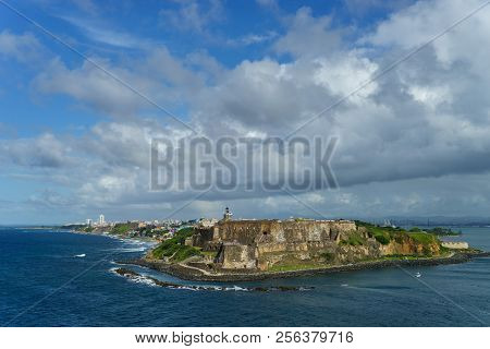Scenic View Of Historic Colorful Puerto Rico City In Distance With Fort In Foreground From The Sea