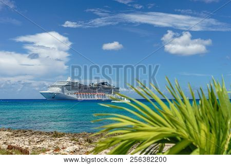 Cruise Ship In Crystal Blue Water With A Palm On The Front
