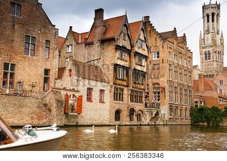 Bruges, Belgium-august 15, 2015-the Belfry Tower And The Medieval Houses At The Canal In Brugge.