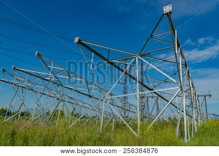 New Poles For Power Lines Lying On The Ground. For The Next Installation In The Design Position.