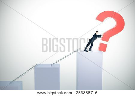 Side View Of Young Businessman Pushing Question Marks On White Background With Abstract Chart Bars A