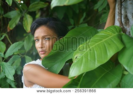 A Beautiful African-looking Girl With Black Short Hair And White Dress Pousing Near The Big Beautifu
