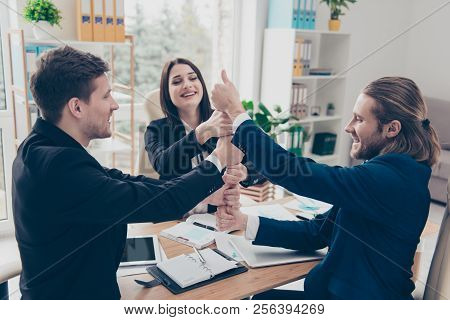 Success Togetherness Concept. Three Elegant Classic Business Sharks In Suits Putting Their Hands Wit