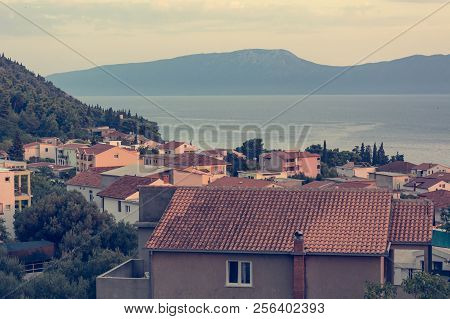 Rooftop View Of Mediterranean Port Town At Sunset.