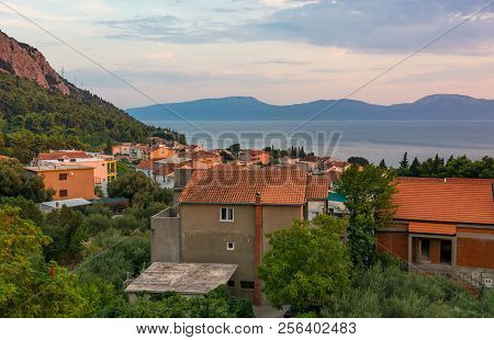 Rooftop View Of Mediterranean Port Town At Sunset.