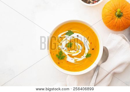 Pumpkin Soup With Cream And Pumpkin Seeds Isolated On White Background. Autumn Concept.