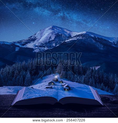 Miniature Alpine Mountain Village At Winter Night Under The Starry Sky On The Pages Of An Open Magic
