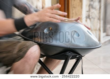 Unrecognized Man On The Street Playing Hang.