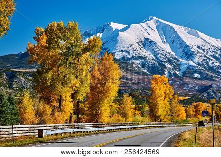 Highway in Colorado Rocky Mountains at autumn, USA. Mount Sopris landscape.