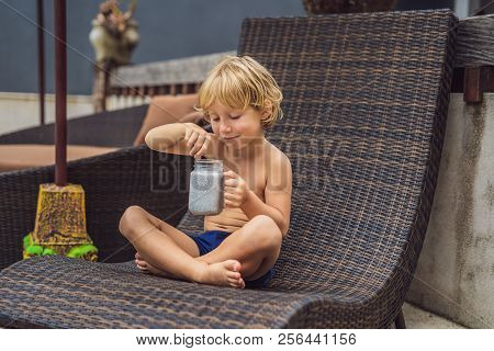 The Boy Eats Chia Pudding In The Morning By The Pool. Healthy Breakfast. Useful Food For Children