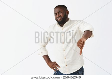 This Place Sucks, Giving My Dislike. Portrait Of Unimpressed Displeased Gloomy Dark-skinned Man In W