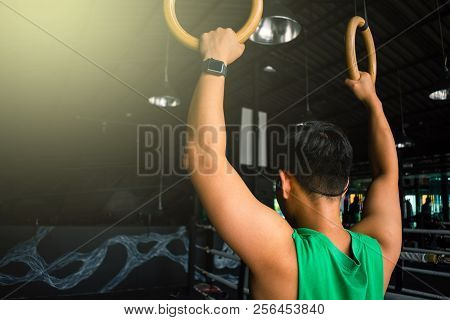 Asian Man Athlete Gymnast Rings Exercise In Gymnastics Exercise Chest 
Workout On Bench Press Cable 