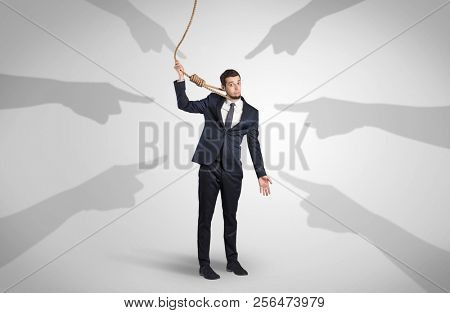 Young businessman trying to suicide with pointing hands concept