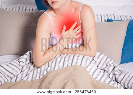 Heart Attack, Woman With Chest Pain Suffering At Home, Painful Area Highlighted In Red