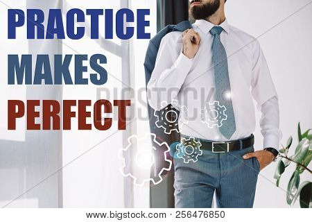 Cropped View Of Businessman Standing Near Window With Practice Makes Perfect Lettering And Gears