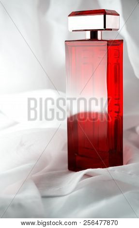 Female Red Perfume On A White Background