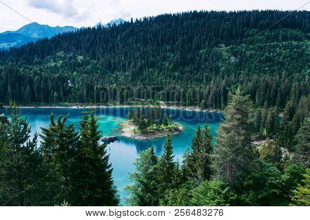 Caumasee Lake With A Small Island Located In The Middle Of The Crystal Clean Lake, Near Flims, Switz