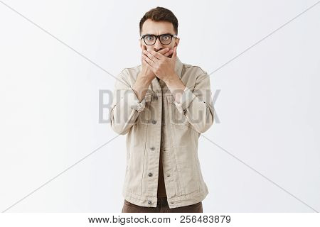 Studio Shot Of Shocked Speechless Displeased Aduly Male With Stylish Hairstyle In Beige Outdoor Jack