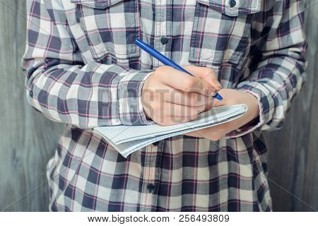 Close-up Photo Of Student's Hand Writing In Notebook
