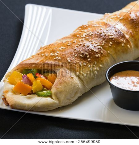Close Up Shot Of Vegtable Calzone On A Plate