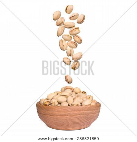Pistachio In Bowl On White Background. Nuts Falling To Wooden Bowl. Levity Kernels.
