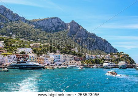 Busy Beach With Boats Docked And People Walking In The Island Of Capri , Italy