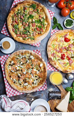 Breakfast Gourmet Pizzas With Eggs, Ham And Lox On The Table Overhead View