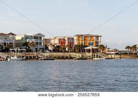Wide Angle View Of Luxury Beach Houses With Boat Dock On The Inter Coastal Waterway, Sunset Beach, N