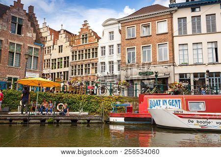 Ghent, Belgium - August 14, 2015 - Old Colorful Traditional Houses And People Along The Canal.